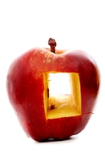 red apple with a hole in it  isolated over a white background.jpeg